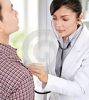 Doctor taking the heartbeat