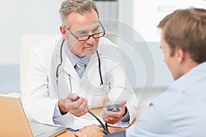 Doctor taking his patients blood pressure