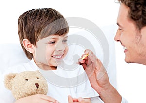 A doctor taking little boy's temperature