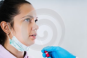 Doctor Taking Mouth Fluid Swab Sample