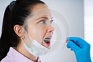 Doctor Taking Mouth Fluid Swab Sample