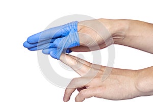 Doctor taking off her blue medical gloves. White background