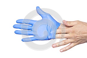 Doctor taking off her blue medical gloves. White background