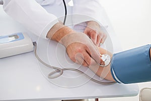 Doctor taking patients blood pressure