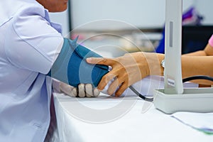 Doctor taking pulse of the patient