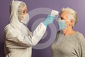 Doctor taking temperature with a non-contact thermometer