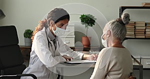 Doctor talk to older patient tells about health test results