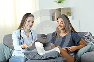 Doctor talking with a disabled outpatient at home photo
