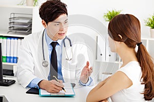 Doctor talking with female patient