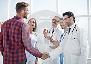 Doctor talking with a guy, shaking hands