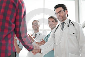 Doctor talking with a guy, shaking hands