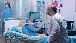 Doctor talking with patient with oxygen mask