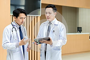 Doctor talking on problem in checklist at hospital.