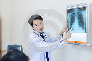 Doctor talking on problem point on x-ray film. x-ray film show skeleton on film. Surgery medical technology concept. Osteoarthriti