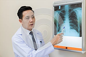 Doctor talking on problem point on x-ray film. x-ray film show skeleton on film. Surgery medical technology concept. Osteoarthriti