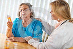 Doctor Talking with Senior Adult Woman About Medicine Prescription