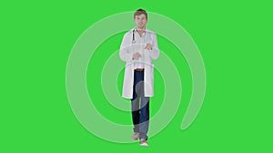 Doctor talking to camera while walking on a Green Screen, Chroma Key.