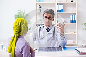 The doctor talking to cancer patient in hospital