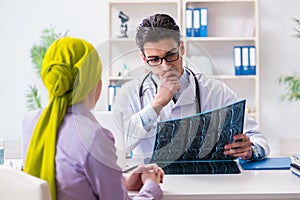 The doctor talking to cancer patient in hospital