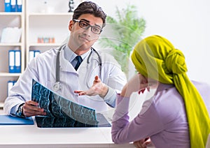 Doctor talking to cancer patient in hospital