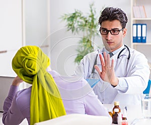 The doctor talking to cancer patient in hospital