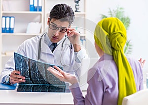 Doctor talking to cancer patient in hospital