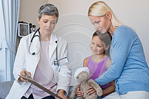 Doctor talking to child and mother
