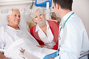 Doctor talking to couple on UK Hospital photo