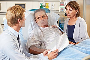 Doctor Talking To Couple On Ward photo