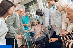 The doctor is talking to an elderly woman in a nursing home.