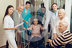 The doctor is talking to an elderly woman in a nursing home.