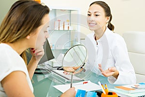 Doctor talking to female client in medicine center