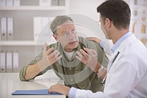 Doctor talking to frightened patient