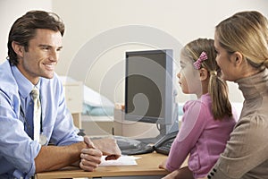 Doctor talking to mother and child