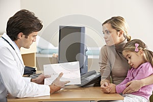 Doctor talking to mother and child