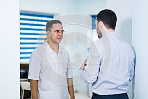 Doctor talking to a patient in a hallway