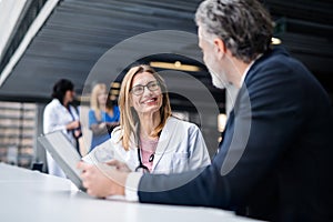 Doctor talking to a pharmaceutical sales representative. photo