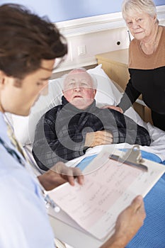 Doctor talking to senior couple in hospital