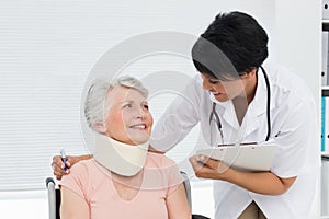 Doctor talking to a senior patient with cervical collar