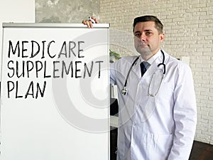 The doctor talks about medicare supplement plan. photo