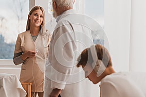 Doctor talks to a fashion nurse in the hospital children`s ward