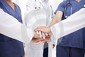 Doctor, teamwork and hands together in meeting, motivation or unity in healthcare mission together at hospital. Closeup
