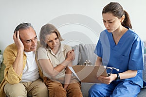 Doctor telling bad diagnosis to sad senior patients man and woman, upset aged couple receiving results of examinations