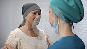 Doctor telling crying cancer patient about bad results of therapy, oncology