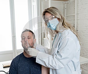 Doctor testing adult man for coronavirus infection performing nasal swab, PCR or rapid COVID-19 test