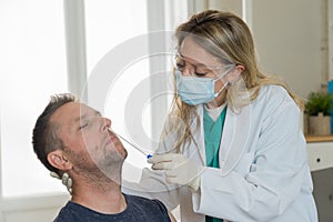 Doctor testing adult man for coronavirus infection performing nasal swab, PCR or rapid COVID-19 test