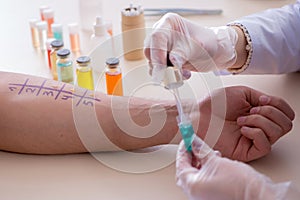 The doctor testing allergy reaction of patient in hospital