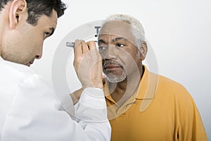 Doctor Testing Patient's Eye At Clinic