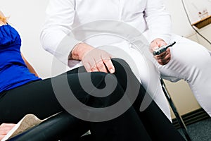 Doctor testing reflexes photo