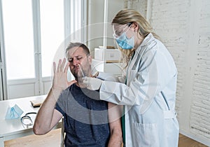 Doctor testing scared adult man for coronavirus infection performing nasal swab, PCR COVID-19 test